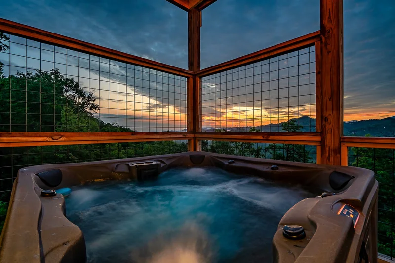 Porch chairs and gas fire table overlooking wooded hills