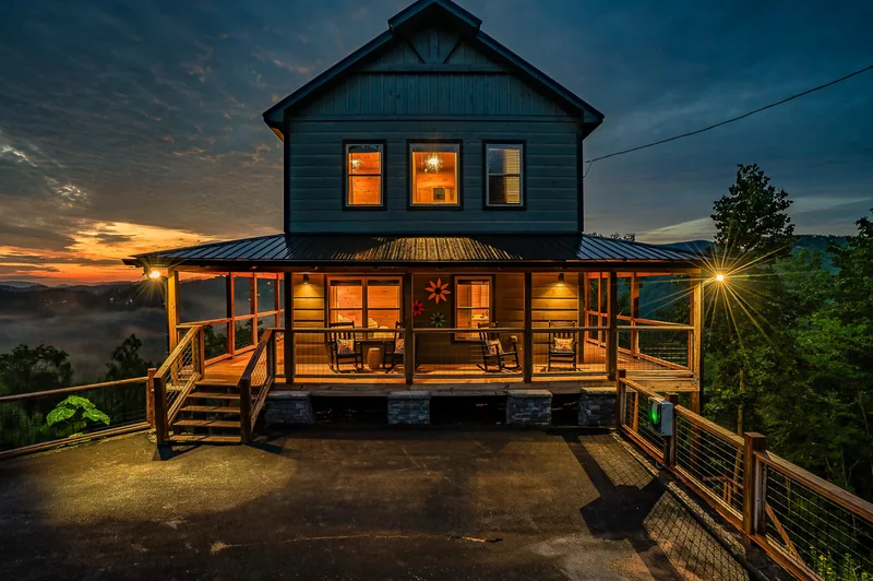 Side view of the cabin with driveway and wooded surroundings
