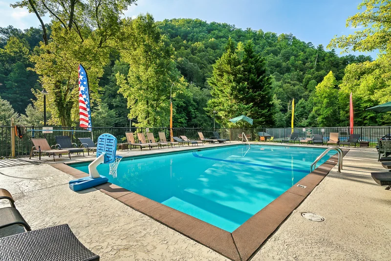 Elevated view of swimming pool deck with rows of lounge chairs