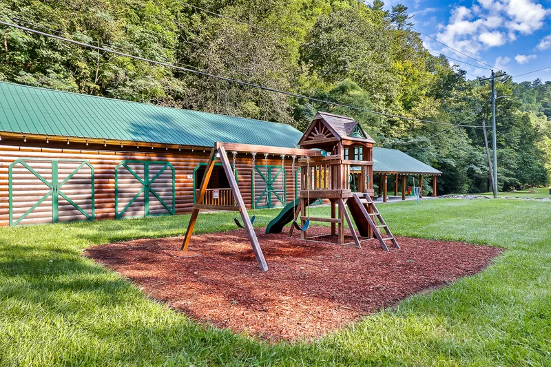 Covered picnic pavilion with tables and oversized Connect Four game